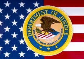 Department of Justice Logo over American Flag - 1200 x 801